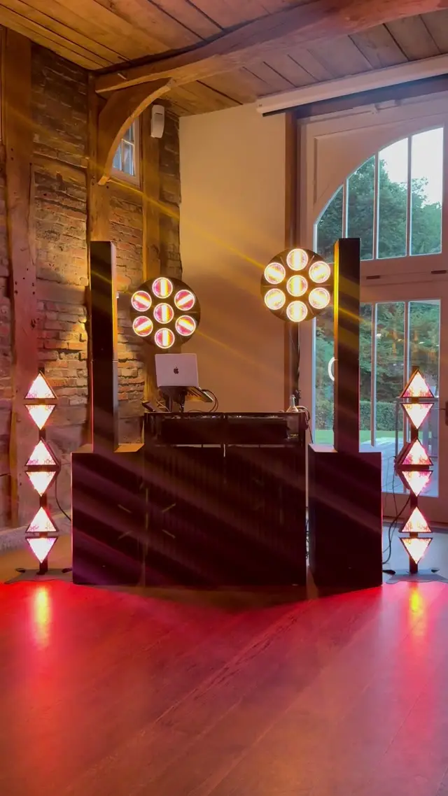 DJ-Pult mit warmem Licht in einer Fachwerkscheune
